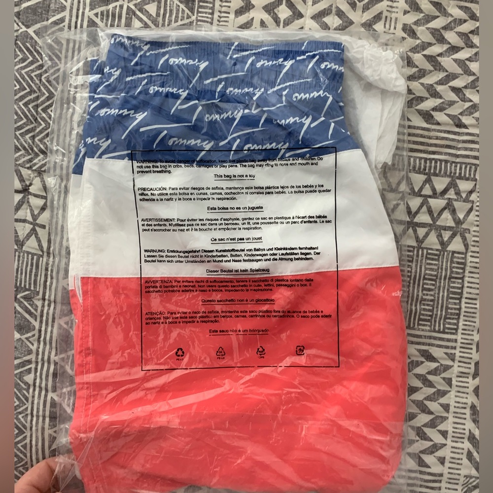 Brand new Tommy swimming trunks size Medium never worn.